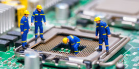 Miniature construction workers fixing a motherboard