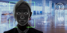 A computer analyzing a female face as part of facial recognition in schools.