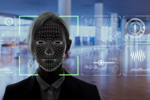 A computer analyzing a female face as part of facial recognition in schools.