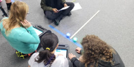 girls on a blacktop completing a challenge with their Spheros