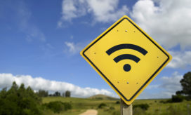 A wi-fi sign on a country road illustrates the idea that internet access for rural students is challenging.