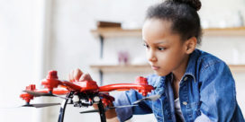 A girl works with a drone--it's important to get more girls in STEM fields.