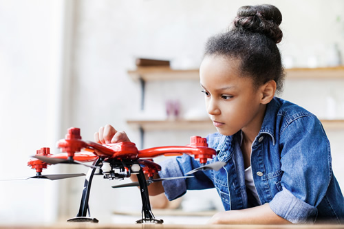 A girl works with a drone--it's important to get more girls in STEM fields.