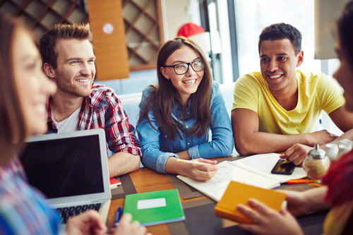 Students gather around a table to study in a school that focuses on improving student motivation.