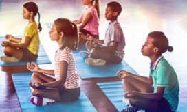 Children on mats, meditating