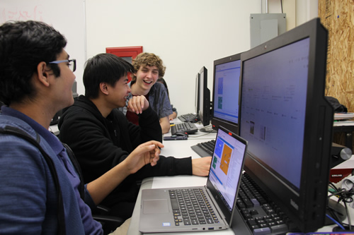 High school students working on designing a solution to real-world problems