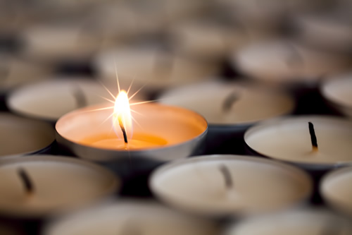 One lit candle demonstrates the idea of resilience in people.