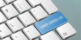 A keyboard displays a key reading "summer learning loss."