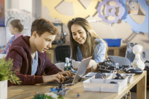 Two students work on robotics in rural schools.