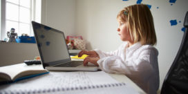 A student using a laptop at home shows why a student safety platform is important for schools.