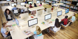 A library with students on computers demonstrates the importance of evaluating a tech tool.