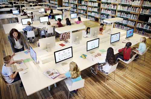 A library with students on computers demonstrates the importance of evaluating a tech tool.
