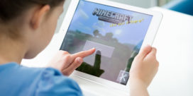 It's easy to start to use Minecraft in the classroom--here, a young student plays Minecraft on an iPad.