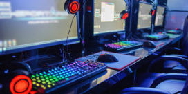 Monitors and headsets sit in a K-12 esports leage's competitive gaming room.