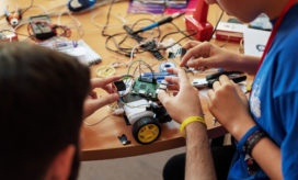 A student and teacher work on a robotics project. If you're looking for a way to add another engaging element to your robotics instruction, check out these K-12 robotics apps.