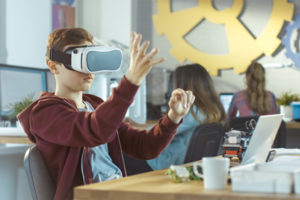 A student wears a virtual reality headset for learning, showing how VR is positioned for the classroom.