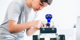This student works on a robot, illustrating the importance of putting robotics in rural schools.