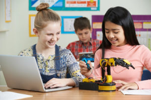 K-12 robotics is finding its place in classrooms--here are some tips to help you incorporate it in your own instruction for students such as these female students working with a robot.