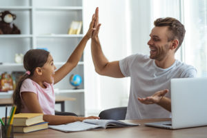 A new student data repository will soon offer access to more useful information on demand, like this father and daughter using a laptop.