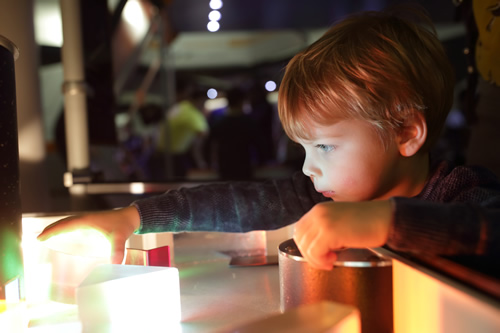Young students can be some of the most enthusiastic STEAM learners--here's how to incorporate engaging STEAM projects into early grades, like this young child studying refraction of light.