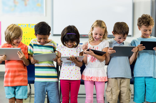 The digital classroom never stays the same--here's what educators say is most important for their students' engagement and learning, like these smiling students using tablets.