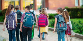 Technology products are helping schools prevent and protect against acts of violence--learn about strategies enabling better school safety, like this group of children walking into school.