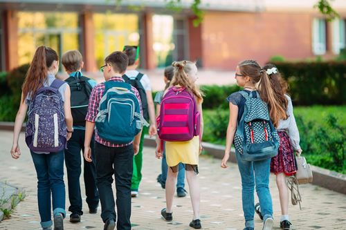 Technology products are helping schools prevent and protect against acts of violence--learn about strategies enabling better school safety, like this group of children walking into school.