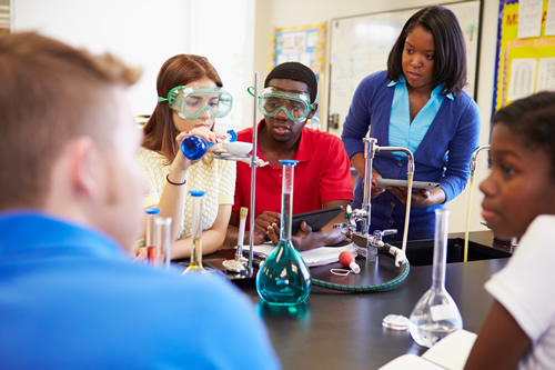 Increasing access to STEM education and internship opportunities can help students in rural communities avoid the dreaded 'brain drain' like these students in a science lab doing an experiment.