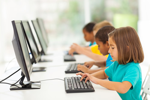 Elementary students in computer class show why keyboarding skills are important for digital natives.