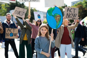 Protesters hold posters about climate change.