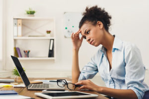 Tech leaders have their plates full--here's how many of them view some of the most stubborn district challenges, like this frustrated woman at a computer.