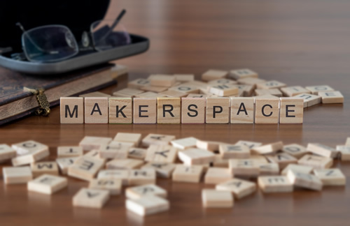 The concept of a school makerspace is represented by loose wooden tiles.