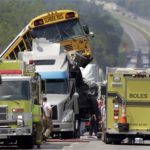 Rescue personnel work at the scene of an accident involving two school buses and a tractor-trailer on Aug. 5 near Gray Summit, Mo.